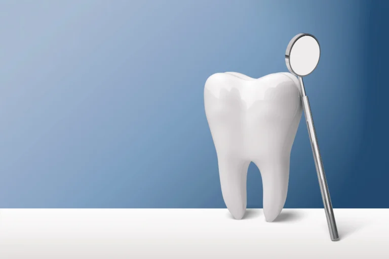 Tooth model standing beside a dental mirror