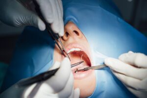 Dentist working in his office with a patient.
