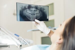 Doctor talking with her patient and teaching a radiograph. Medical Concept.